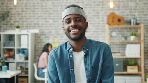 Ritratto di uomo afroamericano gioioso che sorride guardando la macchina fotografica in ufficio — Video Stock