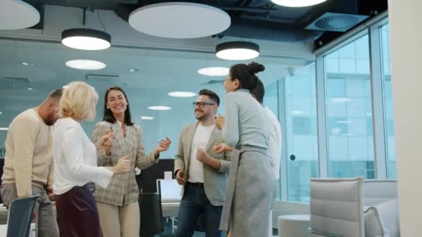 Happy friends male and female dancing in shared office room having fun indoors — Stock video