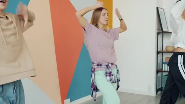 Gyönyörű tizenéves lányok táncolnak a modern stúdióban új mozdulatokat tanulnak mosolyogva — Stock videók