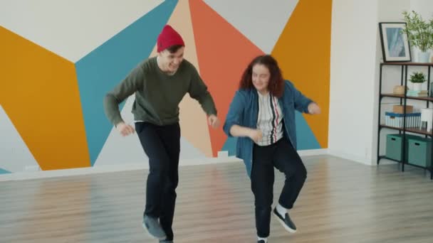Teenage student learning dance moves from female teacher dancing in modern studio — Stock Video
