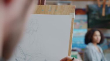 Erkeklerin resim dersinde Afro-Amerikan kız modelinin portresini yakın plan çekimleri.