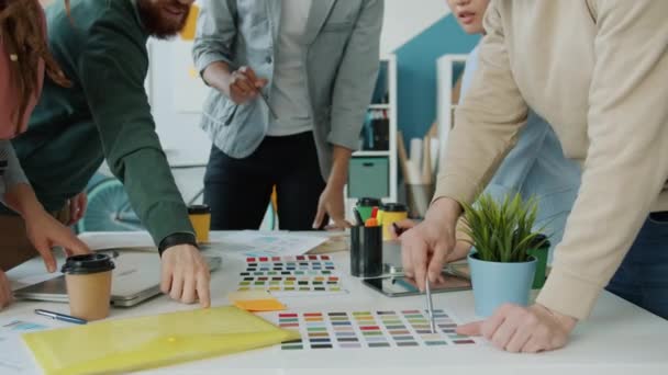 Middle shot of people designers pointing at colors during creative team meeting in office — Stock Video