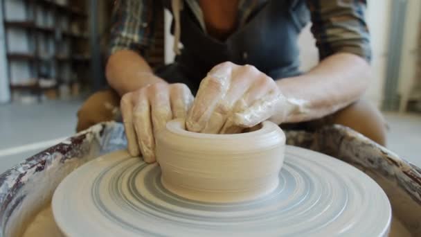 Primer plano de manos de alfareros masculinos que fabrican tazón de cerámica de arcilla utilizando la rueda de lanzamiento — Vídeos de Stock