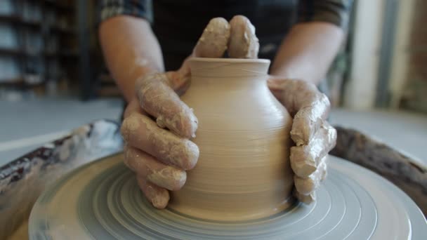 Nahtlose Schleife handgemachter Keramiktöpfe, die sich auf Töpferscheibe in den Händen von Handwerkern drehen — Stockvideo