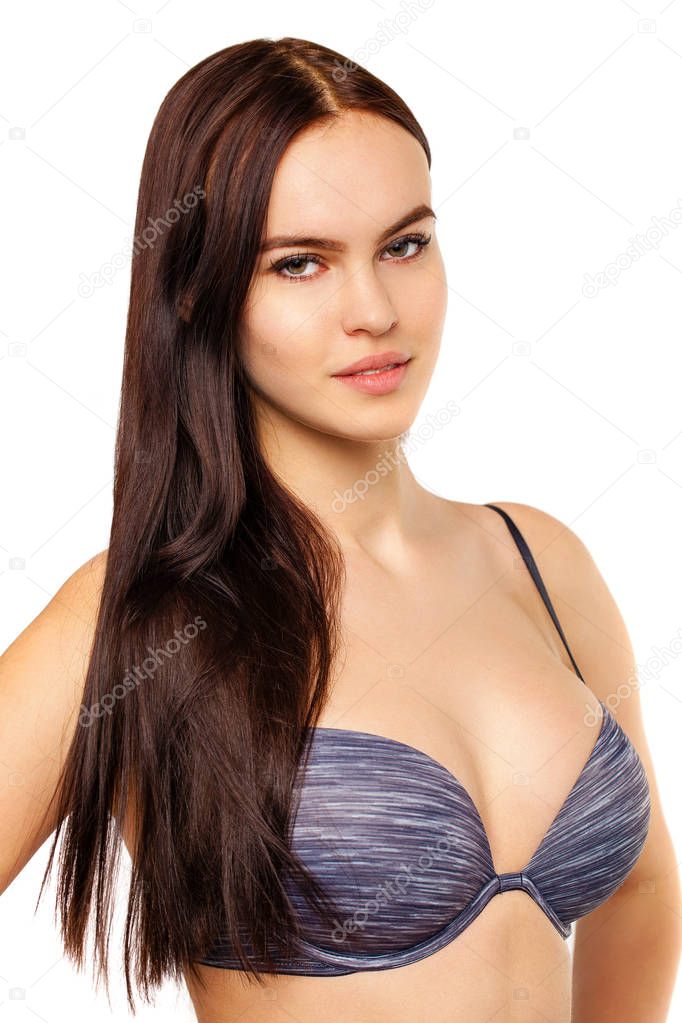 Young sexy brunette woman in blue bra, isolated on white background