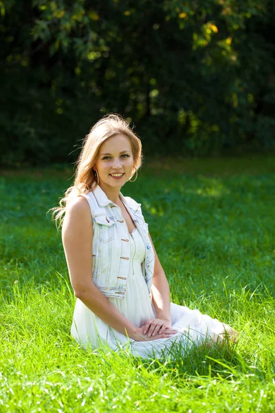 Jovem Mulher Loira Bonita Vestido Branco Sentado Grama Verde Parque — Fotografia de Stock