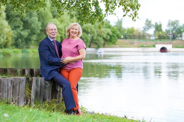 An elderly couple on a walk in a country park