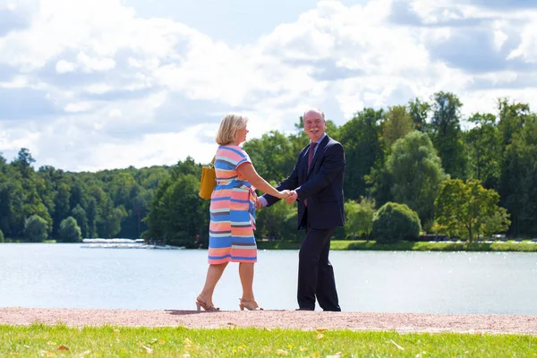 An elderly couple on a walk in a country park