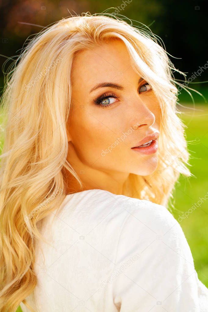 Portrait close up of young beautiful blonde woman, summer outdoors