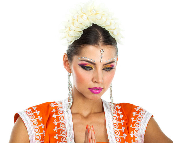 Caucasian brunette woman in orange indian national dress sari in studio on white isolated background 