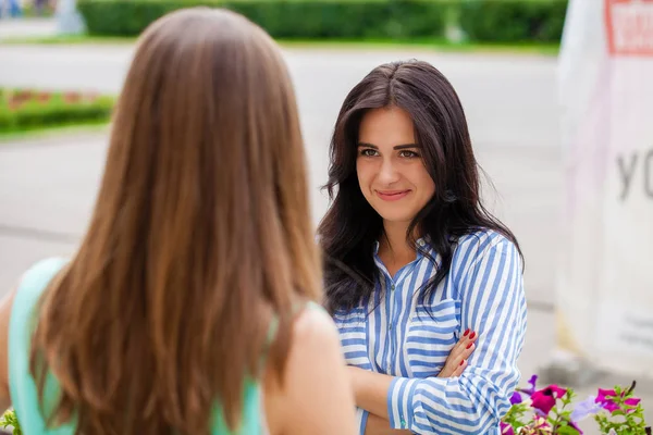 Empty chatter from which the head hurts. Two young women talking on the street — Stock Image Empty Chatter Which Head Hurts Two Young Women Talking Street Stock Picture