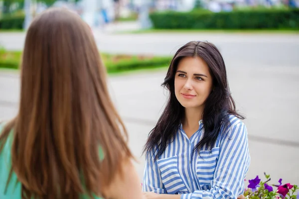 Empty chatter from which the head hurts. Two young women talking on the street — Stock Image Empty Chatter Which Head Hurts Two Young Women Talking Street Royalty Free Stock Photos