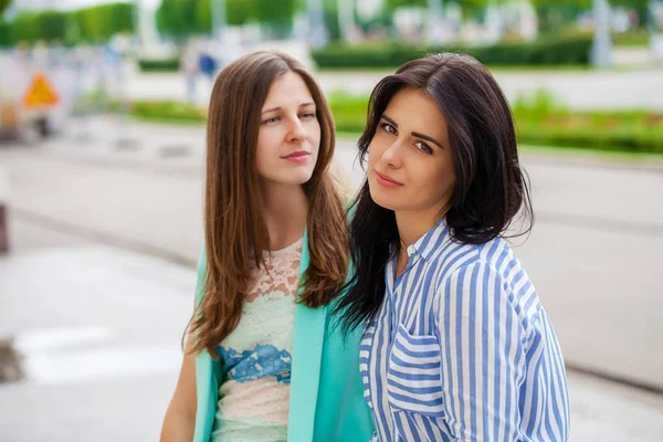 Empty chatter from which the head hurts. Two young women talking on the street — Stock Image Empty Chatter Which Head Hurts Two Young Women Talking Street Stock Image