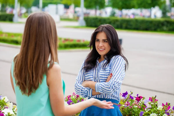 Empty chatter from which the head hurts. Two young women talking on the street — Stock Image Empty Chatter Which Head Hurts Two Young Women Talking Street Stock Picture