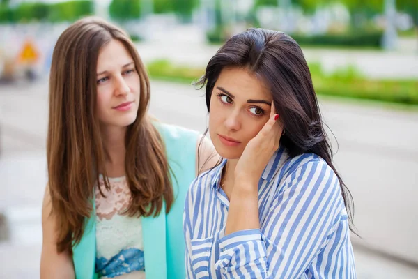 Empty chatter from which the head hurts. Two young women talking on the street — Stock Image Empty Chatter Which Head Hurts Two Young Women Talking Street Royalty Free Stock Photos
