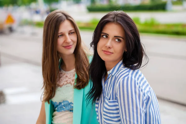 Empty chatter from which the head hurts. Two young women talking on the street — Stock Image Empty Chatter Which Head Hurts Two Young Women Talking Street Stock Image
