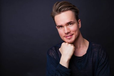 Karanlık bir arka plan üzerinde genç bir adam portresi stüdyo