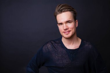 Karanlık bir arka plan üzerinde genç bir adam portresi stüdyo