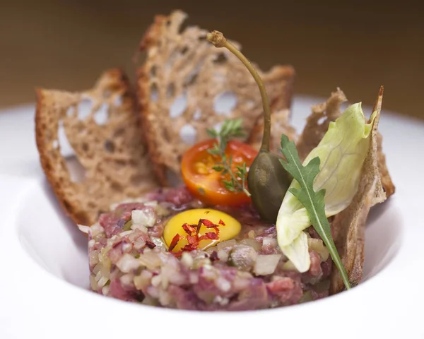 Marbled beef tartare on a white plate — Stock Photo, Image