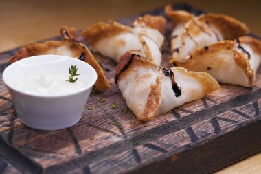 Kızarmış köfte bir ahşap tepsi baharatlı sos ile