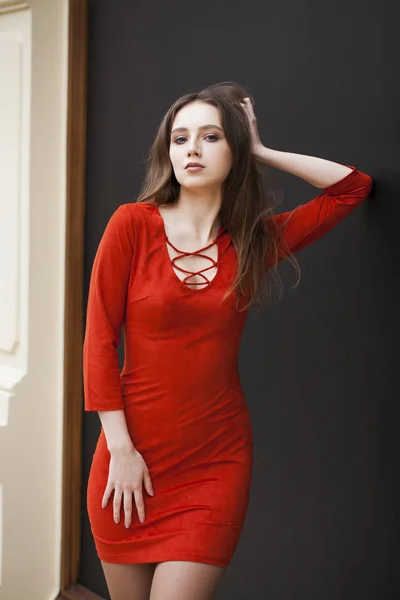 Young beautiful brunette model in red dress — Stock Photo, Image