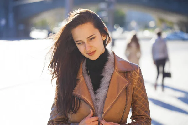 Young happy woman in brown leather jacket — Stock Photo, Image