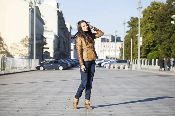 Young happy woman in brown leather jacket — Stock Photo, Image