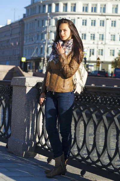 Young happy woman in brown leather jacket — Stock Photo, Image