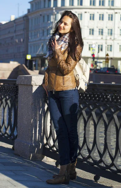 Young happy woman in brown leather jacket — Stock Photo, Image