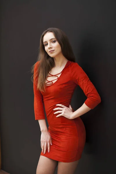 Young beautiful brunette model in red dress — Stock Photo, Image