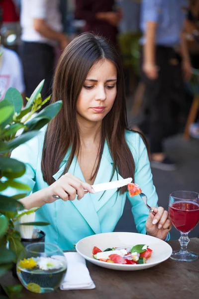 Ung, vakker kvinne spiser frokost på kafeen. – stockfoto