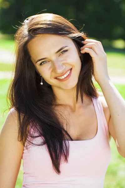 Beautiful brunette woman in sexy pink dress — Stock Photo, Image