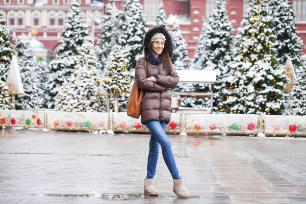 Portrait of a young brunette woman in down jacket — Stock Photo, Image