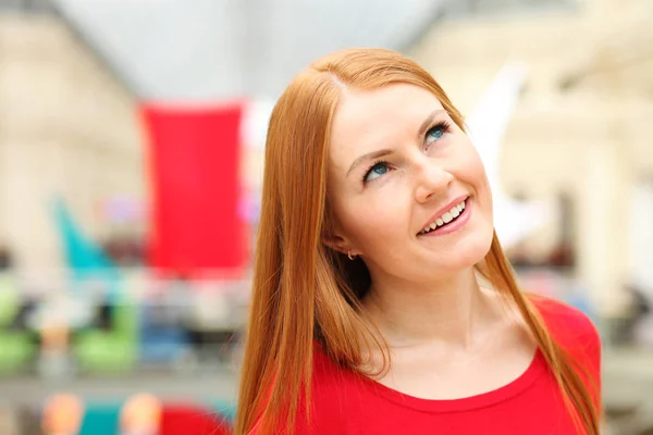 Portrait of a young red-haired woman in a red jumper — Stock Photo, Image