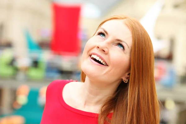 Portrait of a young red-haired woman in a red jumper — Stock Photo, Image