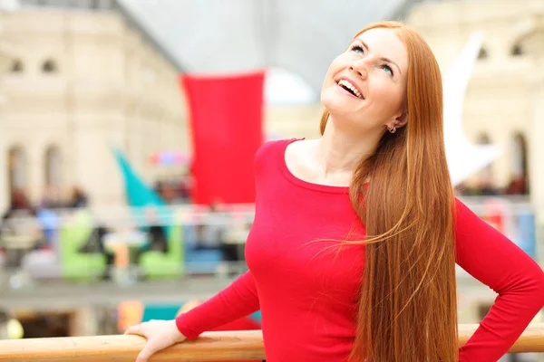 Portrait of a young red-haired woman in a red jumper — Stock Photo, Image