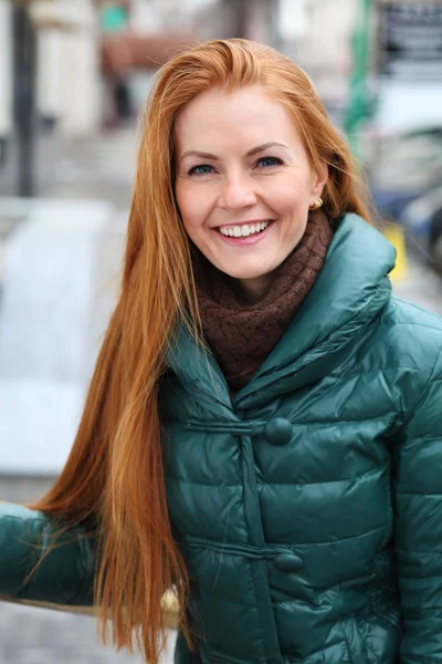 Portrait of pretty sexy young red hair woman in green down jacke — Stock Photo, Image