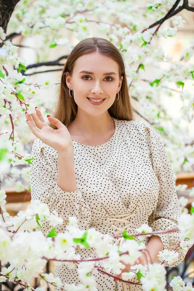 Close up, Young beautiful woman in white blouse in spring flower — Stock Photo, Image