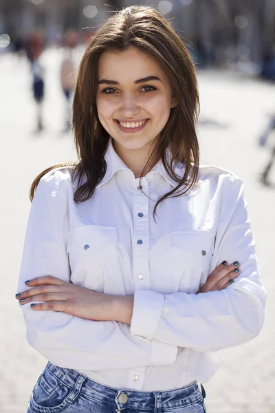 Fiatal gyönyörű barna lány fehér inget pózol a tavaszi PA — Stock Fotó
