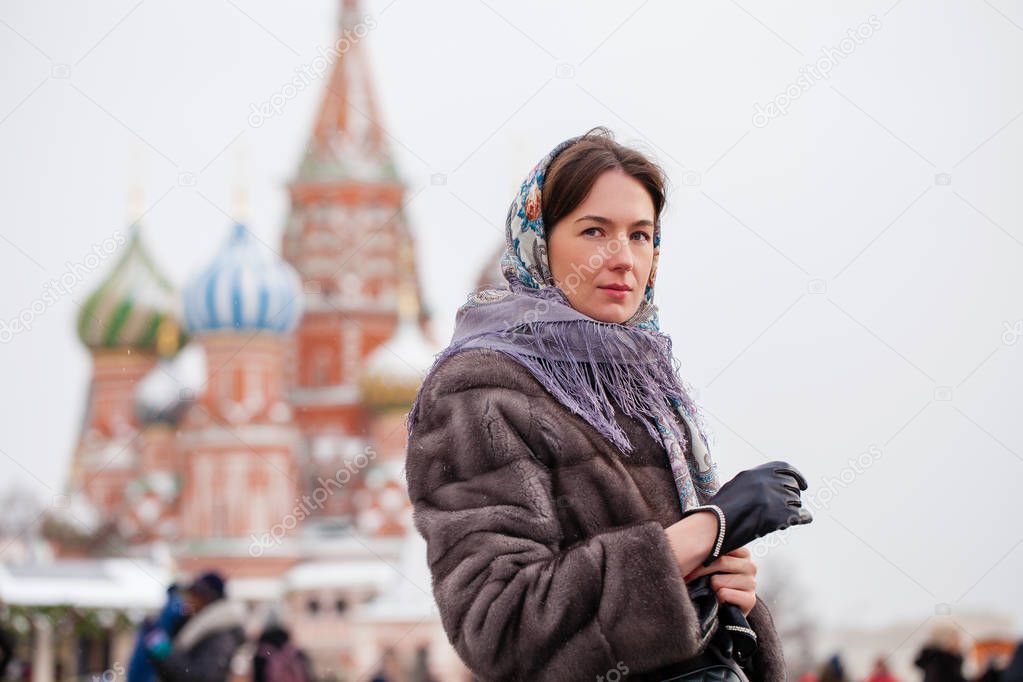 Young woman in fur mink coat on a red square in the center of Mo