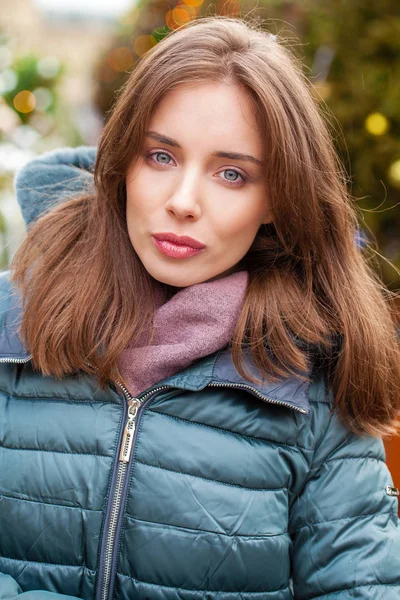 Closeup portrait of a young woman in the winter down jacket — Stock Photo, Image