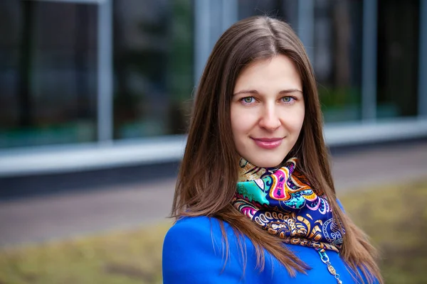 Portrait of a young beautiful woman in blue coat — Stock Photo, Image