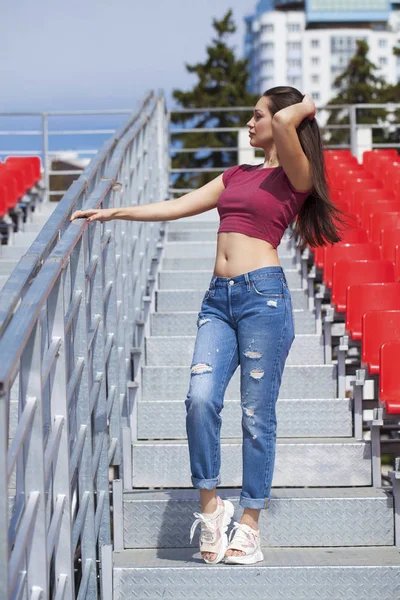 Back view. Portrait of young brunette woman in blue jeans — Stock Photo, Image