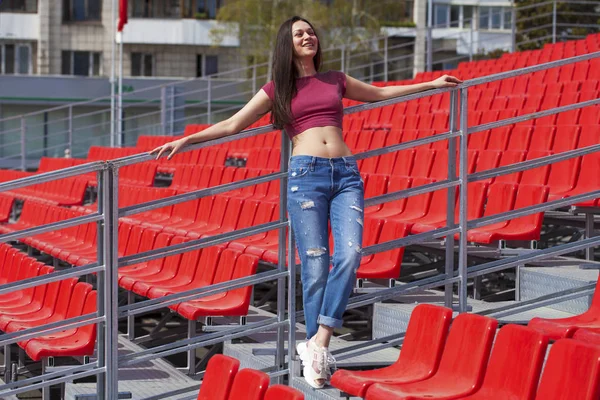 Vista traseira. Retrato de jovem morena em jeans azuis — Fotografia de Stock