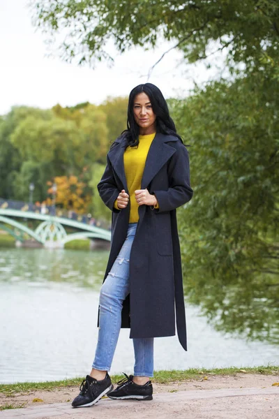 Portrait of a young beautiful woman in gray coat — Stock Photo, Image