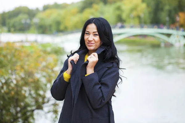 Portrait of a young beautiful woman in gray coat — Stock Photo, Image