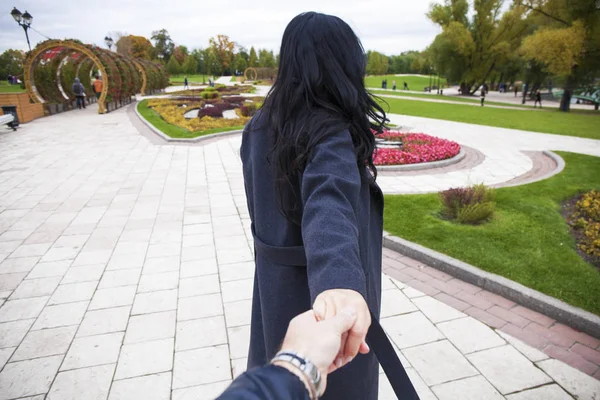 Beautiful sexy young woman holds the hand of a man — Stock Photo, Image