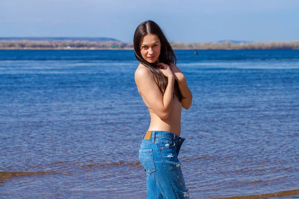 Sexy brunette young woman posing flirty topless at river — Stock Photo, Image