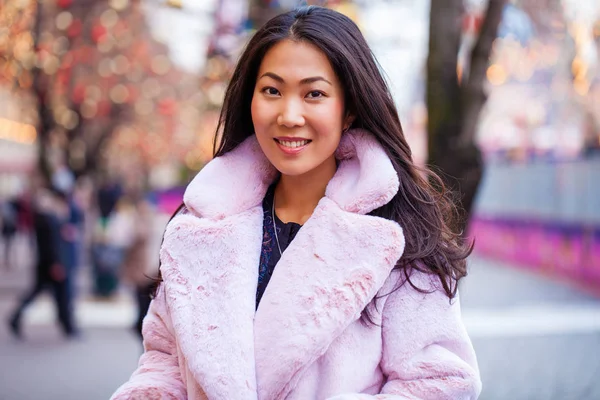 Happy asian woman in winter coat from faux fur — Stock Photo, Image