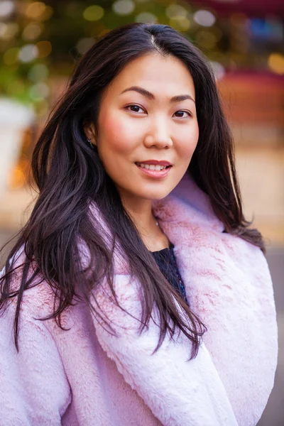 Happy asian woman in winter coat from faux fur — Stock Photo, Image